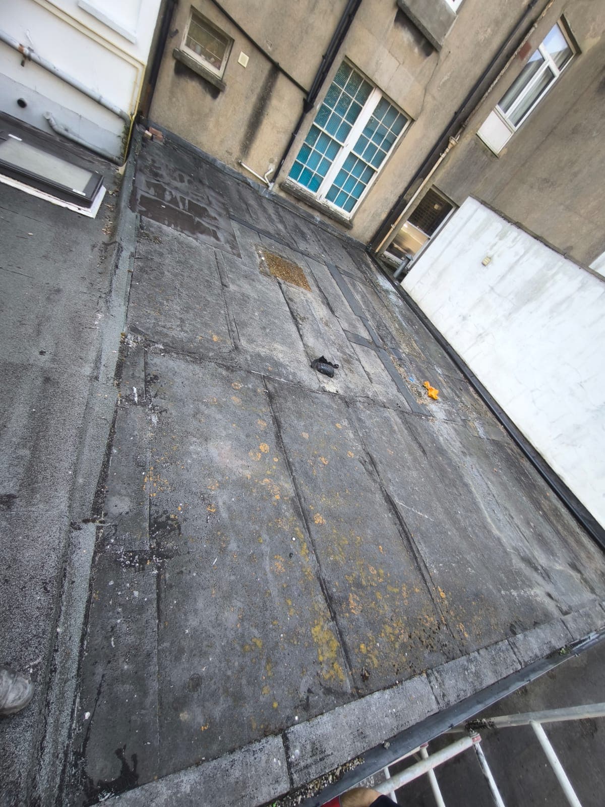 Worn flat roof before PMMA refurbishment